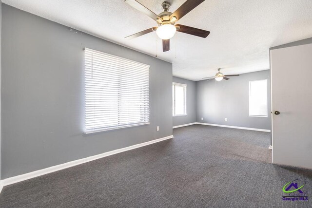 127 Stoneridge Dr, Warner Robins, GA 31088 - unfurnished room featuring dark carpet, a textured ceiling, baseboards, and ceiling fan
