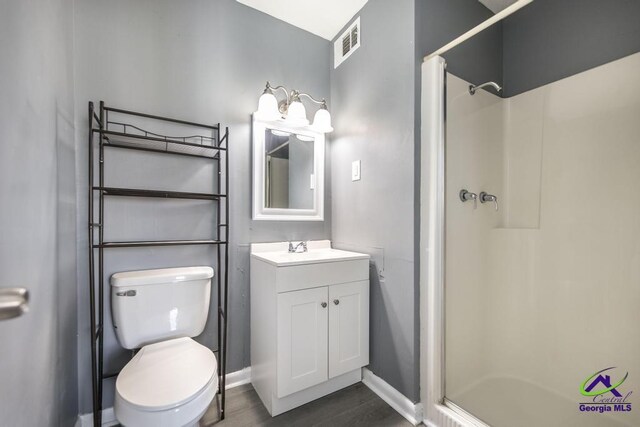 127 Stoneridge Dr, Warner Robins, GA 31088 - full bathroom featuring vanity, baseboards, visible vents, a stall shower, and toilet