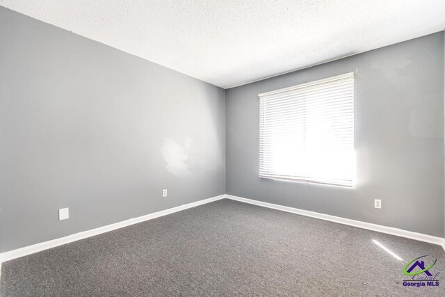 127 Stoneridge Dr, Warner Robins, GA 31088 - carpeted spare room with baseboards and a textured ceiling