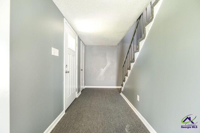 127 Stoneridge Dr, Warner Robins, GA 31088 - corridor featuring stairway, baseboards, carpet, and a textured ceiling