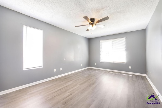 127 Stoneridge Dr, Warner Robins, GA 31088 - spare room featuring ceiling fan, baseboards, a textured ceiling, and wood finished floors