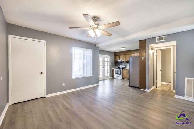 127 Stoneridge Dr, Warner Robins, GA 31088 - unfurnished living room featuring visible vents, baseboards, a ceiling fan, and wood finished floors