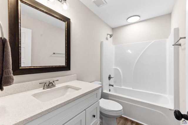 616 Whispering Pines Dr, Macon, GA 31211 - bathroom with visible vents, toilet, wood finished floors, shower / bathing tub combination, and vanity