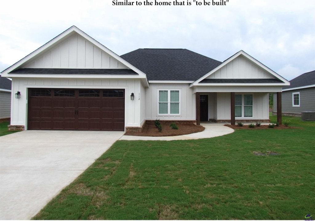 108 Nash Ct, Perry, GA 31069 - view of front of house featuring a front lawn, driveway, board and batten siding, roof with shingles, and an attached garage
