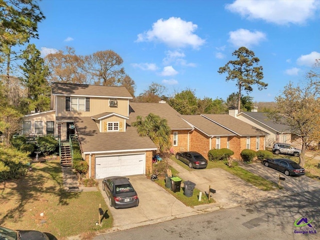 101 Leisure Lake Ct, Warner Robins, GA 31088 - view of front of property with stairway, a garage, concrete driveway, and a shingled roof