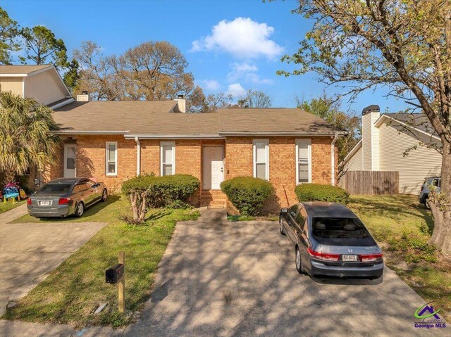 101 Leisure Lake Ct, Warner Robins, GA 31088 - ranch-style home with brick siding, a chimney, a front lawn, and fence