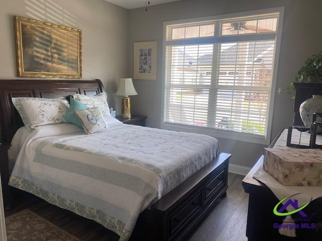 bedroom featuring dark wood-type flooring and baseboards