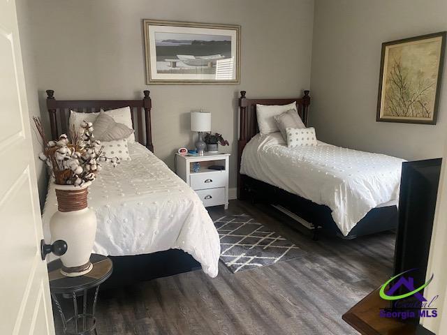 bedroom with dark wood finished floors