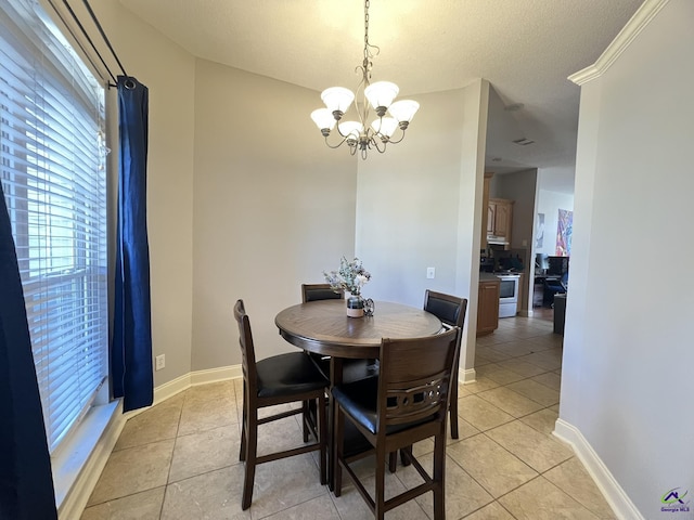 dining area with a chandelier, light tile patterned floors, and baseboards