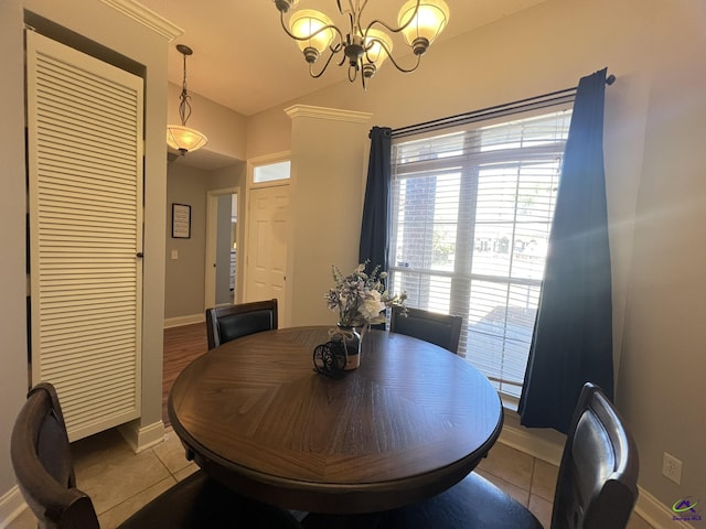 dining room with tile patterned flooring, a notable chandelier, and baseboards