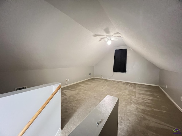 additional living space with lofted ceiling, a ceiling fan, baseboards, and carpet floors