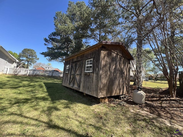 view of shed featuring fence