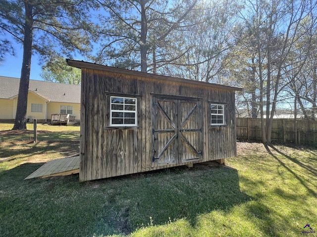 view of shed featuring fence