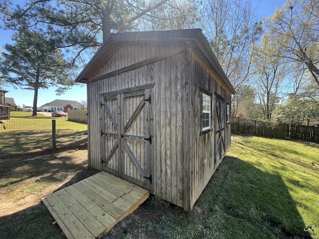 view of shed featuring fence