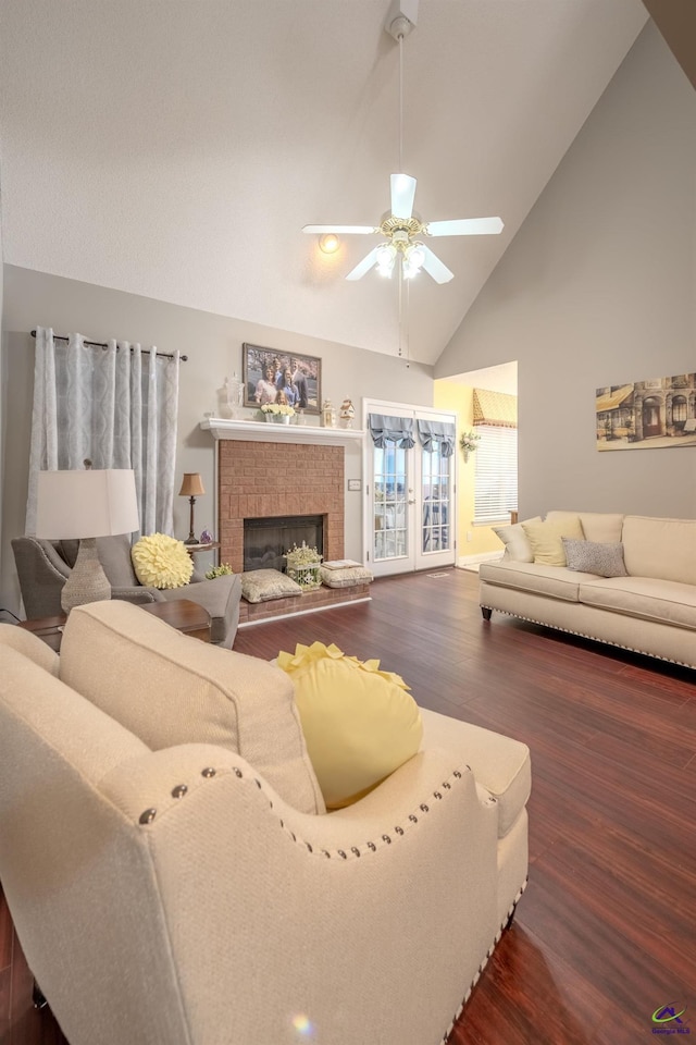 living room featuring a fireplace, wood finished floors, a ceiling fan, and high vaulted ceiling
