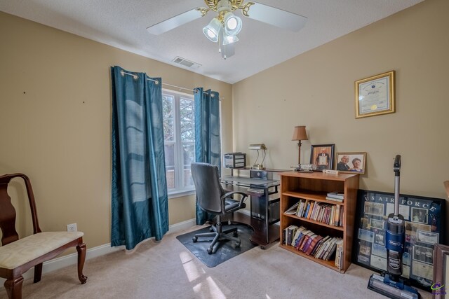 office featuring carpet, baseboards, visible vents, ceiling fan, and a textured ceiling