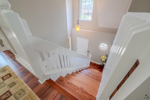 stairway featuring wood finished floors and baseboards