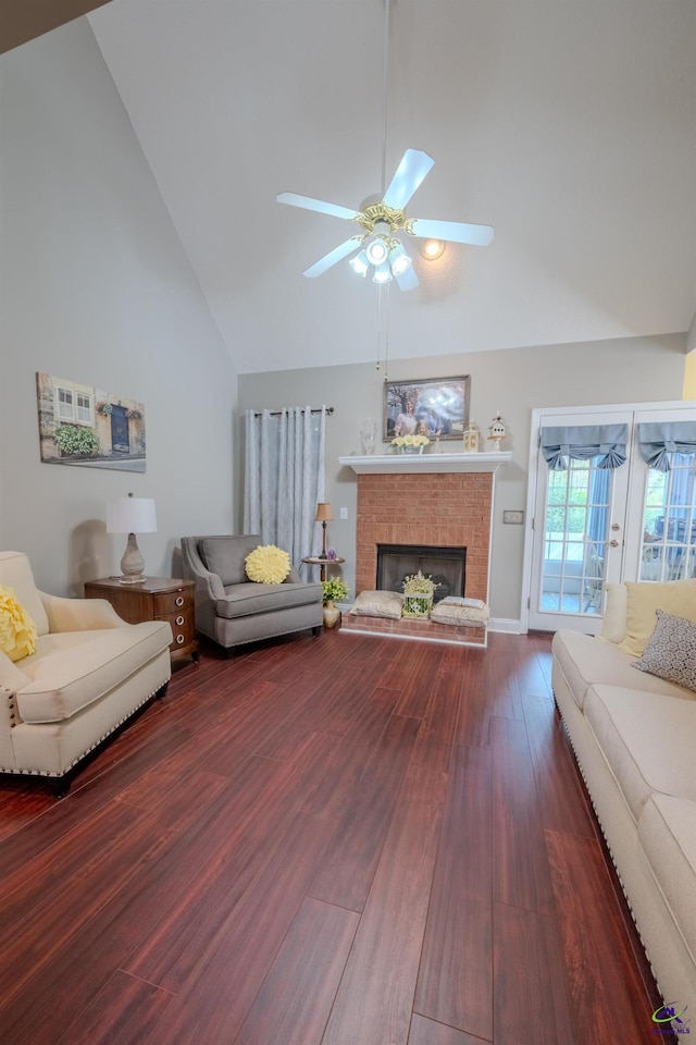 living area with wood finished floors, high vaulted ceiling, ceiling fan, and a fireplace