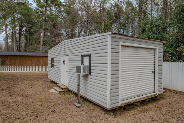 view of shed featuring cooling unit and fence