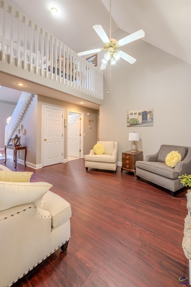 living room with wood finished floors, a ceiling fan, baseboards, and high vaulted ceiling