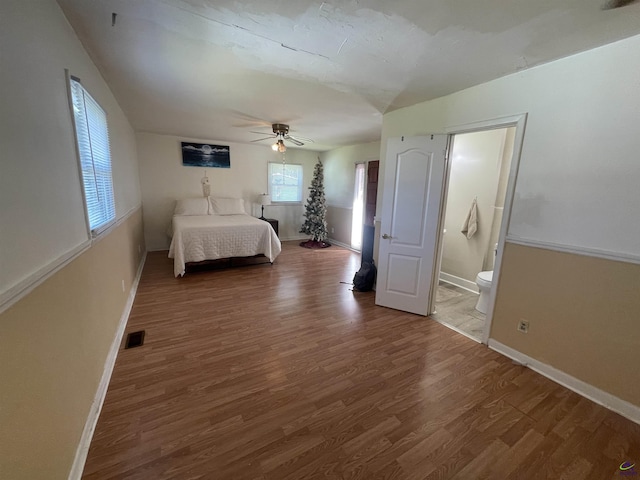 78 Duncan St, Fort Valley, GA 31030 - bedroom with wood finished floors, ensuite bath, and a ceiling fan