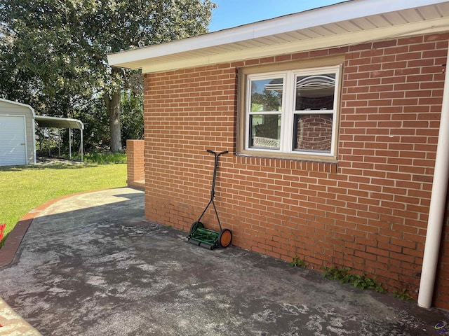 78 Duncan St, Fort Valley, GA 31030 - view of property exterior featuring a lawn, a patio area, and brick siding