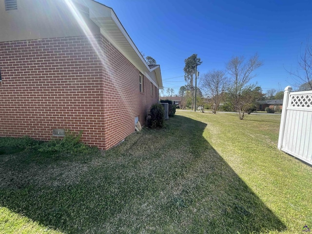 78 Duncan St, Fort Valley, GA 31030 - view of property exterior featuring brick siding, a lawn, and crawl space