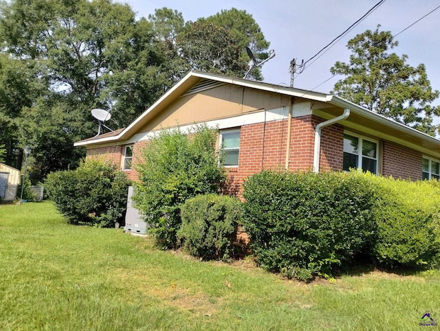 78 Duncan St, Fort Valley, GA 31030 - view of side of property with brick siding and a lawn