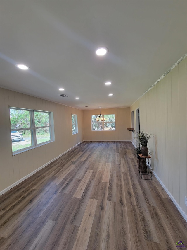 unfurnished living room featuring baseboards, wood finished floors, and recessed lighting
