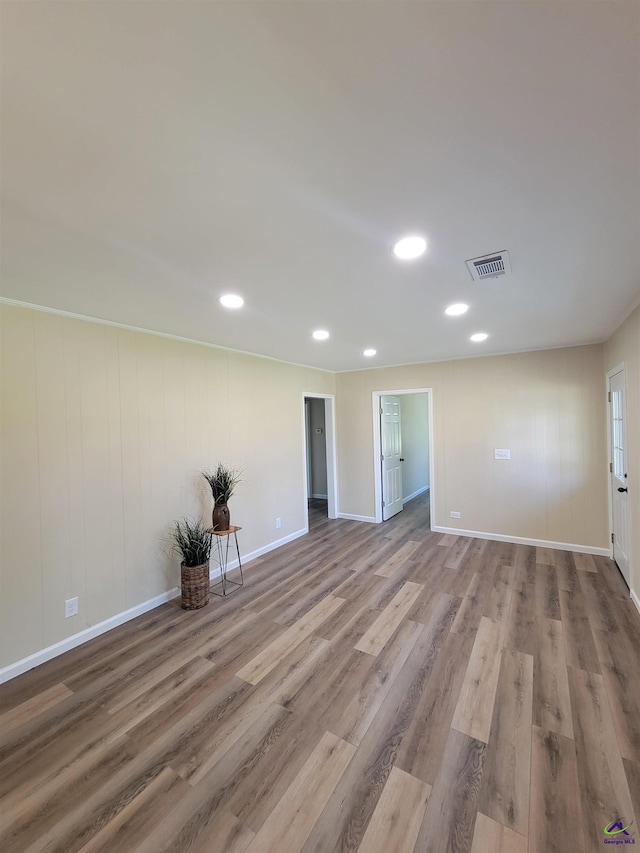 spare room featuring baseboards, visible vents, wood finished floors, and recessed lighting