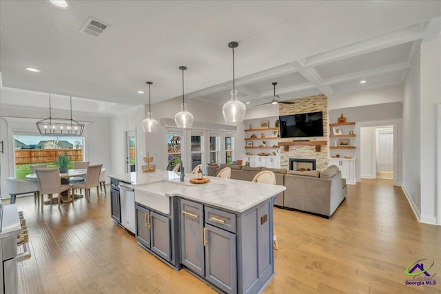 kitchen with visible vents, gray cabinets, coffered ceiling, and light wood finished floors
