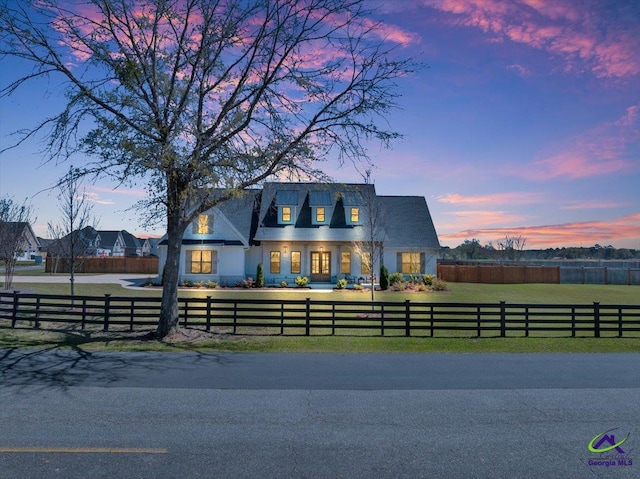 view of front facade featuring a lawn and a fenced front yard