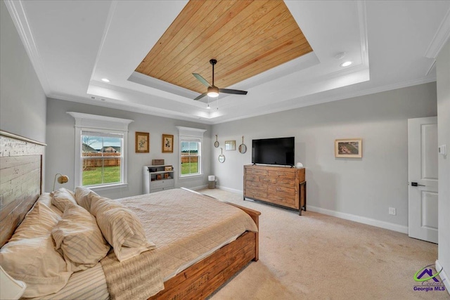 bedroom featuring a tray ceiling, crown molding, baseboards, light colored carpet, and ceiling fan