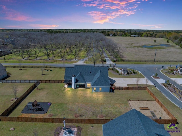 aerial view at dusk featuring a rural view