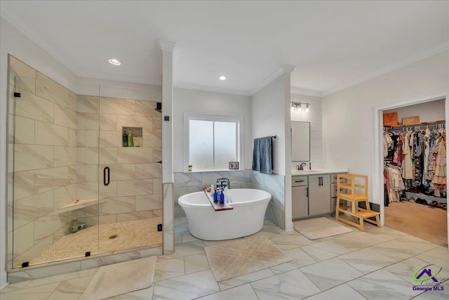 full bathroom with vanity, tile walls, ornamental molding, a stall shower, and a freestanding bath