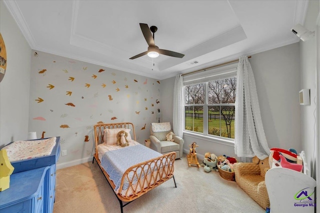 bedroom with baseboards, light colored carpet, visible vents, and a raised ceiling