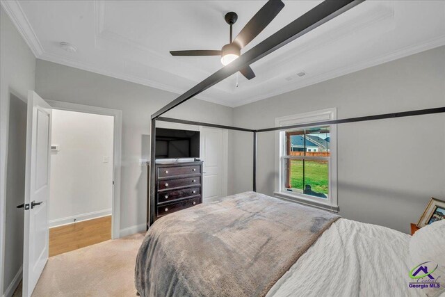 bedroom featuring ornamental molding, baseboards, visible vents, a ceiling fan, and light carpet