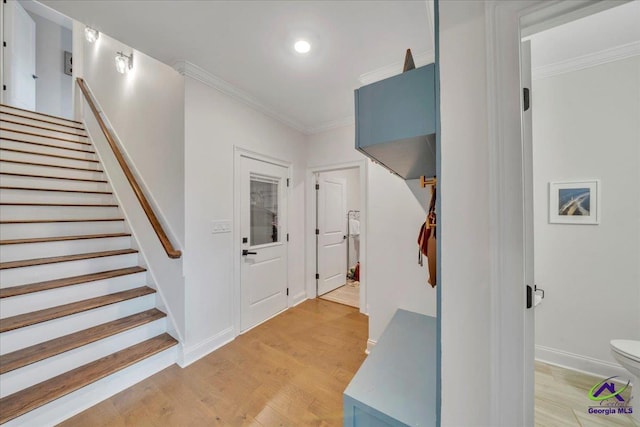 staircase featuring recessed lighting, crown molding, baseboards, and wood finished floors