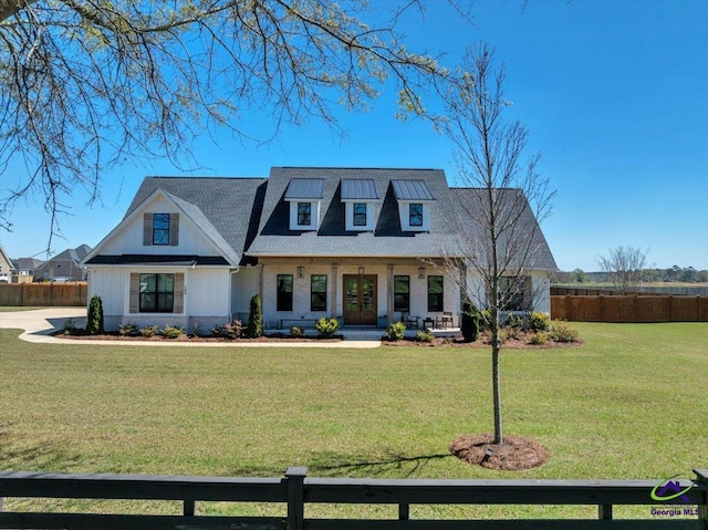 view of front of property with french doors, a porch, fence, and a front lawn