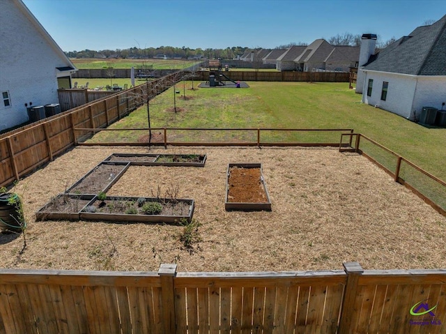 view of yard featuring fence and a garden