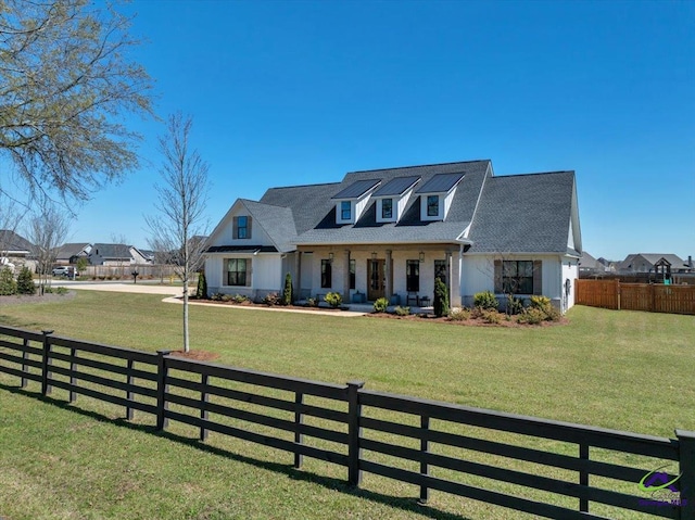 view of front of property featuring a fenced front yard and a front lawn