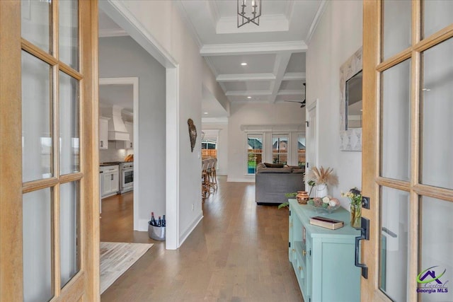 entrance foyer featuring coffered ceiling, beam ceiling, wood finished floors, recessed lighting, and ornamental molding