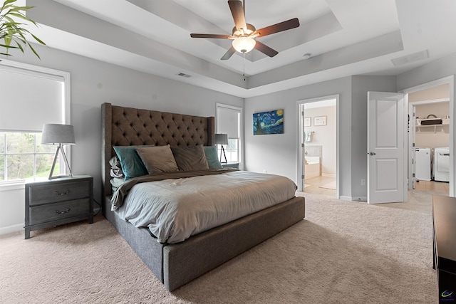 116 Hidesta Ct, Kathleen, GA 31047 - bedroom featuring a tray ceiling, visible vents, washer and clothes dryer, and light colored carpet
