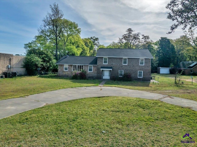 view of front facade with a front lawn, cooling unit, fence, and concrete driveway