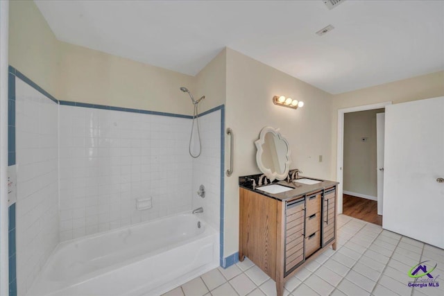 bathroom featuring tile patterned floors, tub / shower combination, and vanity