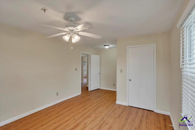 unfurnished bedroom with light wood finished floors, baseboards, and a ceiling fan