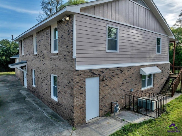 view of home's exterior featuring a patio and stairway