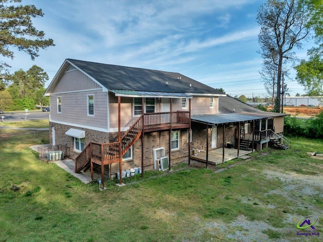 rear view of house with a patio, brick siding, ac unit, and a yard