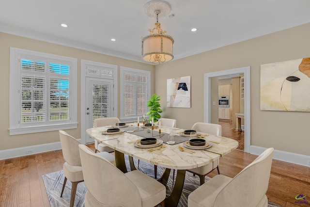 dining area with hardwood / wood-style floors, ornamental molding, baseboards, and recessed lighting