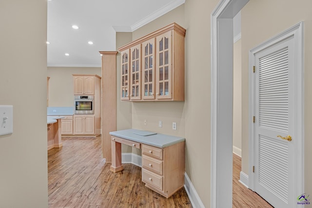 kitchen with crown molding, stainless steel oven, light brown cabinetry, light wood-style flooring, and glass insert cabinets